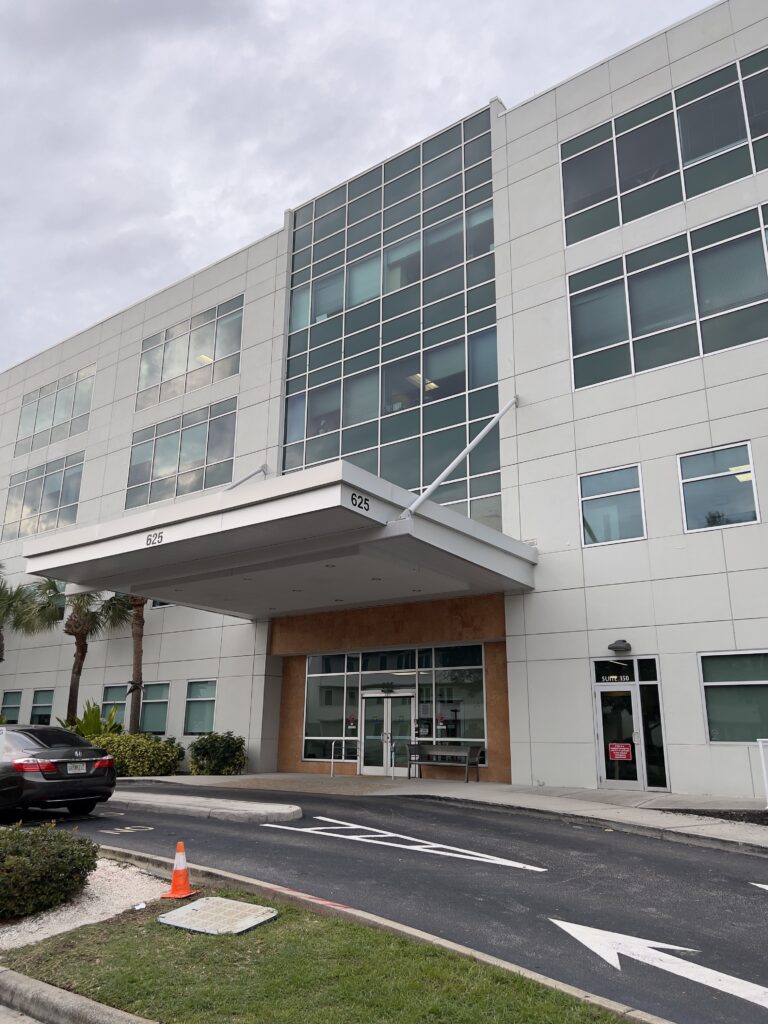 Exterior of the Metro Healthy Communities Downtown St. Pete location, featuring a large white awning with the number 625 above the glass entrance.