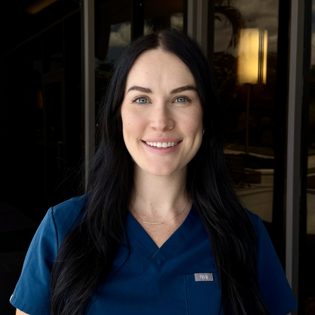 Photo of an APRN with a dark blue shirt against a dark background.