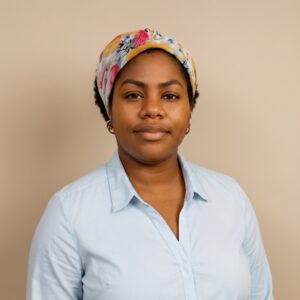 Headshot of a woman wearing a blue shirt and colorful headscarf.